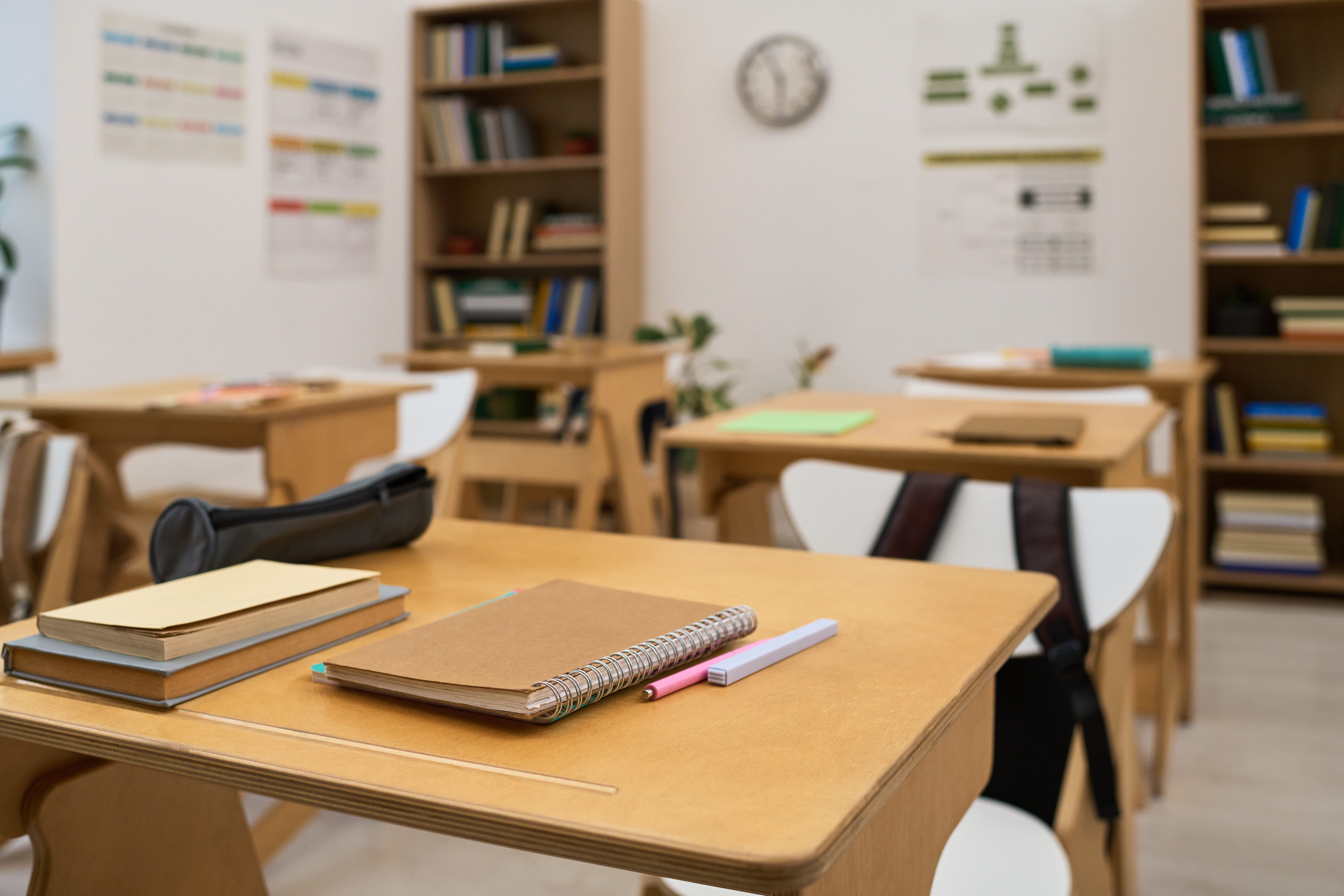 empty-classroom-showing-student-desks-with-notebooks-stationery-items.jpg